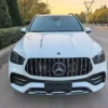 Mercedes-AMG GLE 53 4MATIC+ SUV 01 Performance-Driven Highlights (Rear View): Model Identification: Clearly badged as the "GLE 53" and "AMG", denoting its position as a performance-tuned model. AMG Exhaust System: Features a quad-outlet exhaust (four round tailpipes) integrated into the rear diffuser, which signifies the potent AMG-enhanced 3.0L inline-six turbo engine. This exhaust is known for its performance symphony, which can be conducted via AMG DYNAMIC SELECT. Sporty Rear Diffuser: The prominent lower rear valance/diffuser adds an aggressive, aerodynamic look, typical of AMG's styling cues. Modern LED Taillights: Equipped with sleek LED taillamps for a sophisticated, modern light signature and superior visibility. SUV Utility: Features a power liftgate and ample cargo capacity behind the rear seats, providing the necessary practicality of an SUV